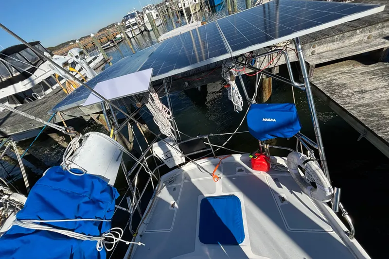 Slide: The Image of 1987 Irwin 44 sailboat with solar panels docked at a marina. - 14