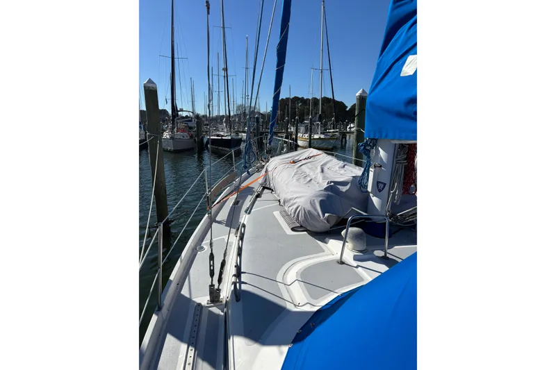 Slide: The Image of 1987 Irwin 44 sailboat docked at marina, clear blue sky, covered deck. - 16