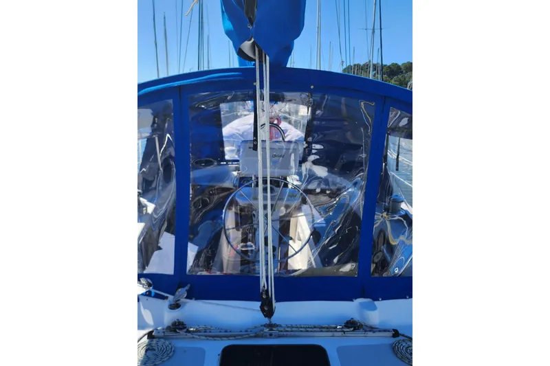 Slide: The Image of 1987 Irwin 44 sailboat cockpit with blue canopy and clear panels. - 2