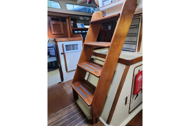Slide: The Image of Interior of 1987 Irwin 44 sailboat with wooden steps and nautical decor. - 21
