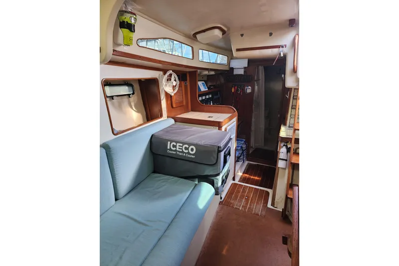 Slide: The Image of Interior of 1987 Irwin 44 sailboat with seating, cooler, and wooden accents. - 24