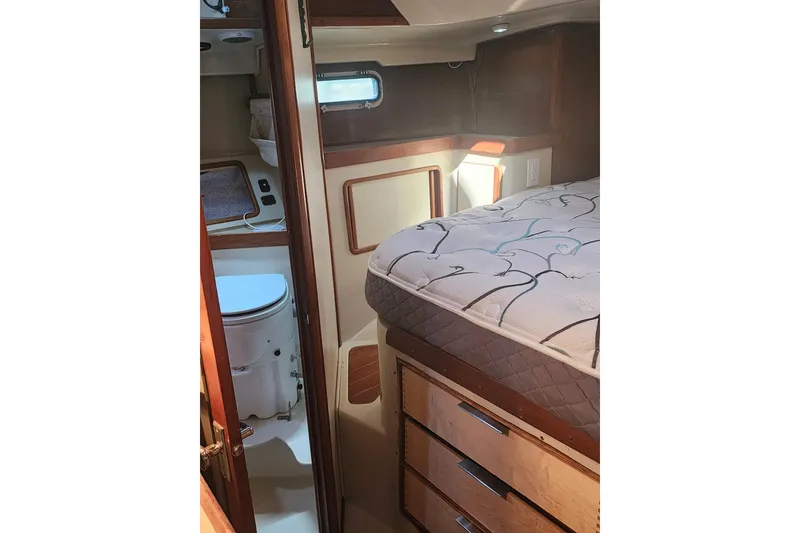 Slide: The Image of 1987 Irwin 44 yacht interior with bed, drawers, and compact bathroom. - 29