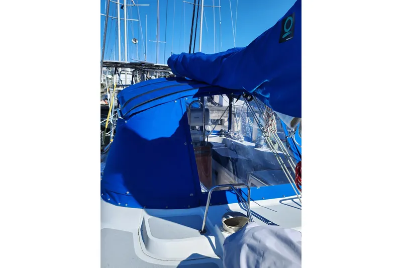 Slide: The Image of 1987 Irwin 44 sailboat with blue canopy in marina setting. - 3
