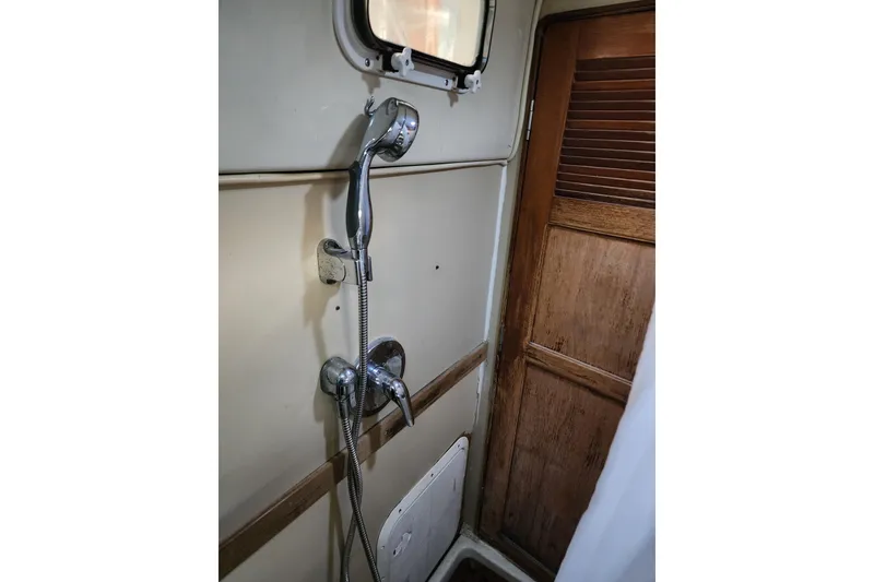 Slide: The Image of Shower area in 1987 Irwin 44 sailboat with wooden door and chrome fixtures. - 33