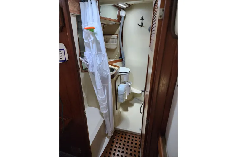 Slide: The Image of 1987 Irwin 44 sailboat bathroom with shower, toilet, and wooden accents. - 36