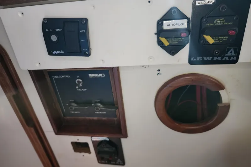 Slide: The Image of Control panel of a 1987 Irwin 44 sailboat with bilge pump and autopilot switches. - 40