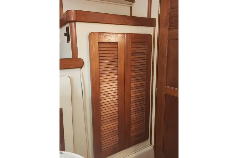 Slide: The Image of 1987 Irwin 44 yacht interior with wooden louvered cabinet doors. - 45
