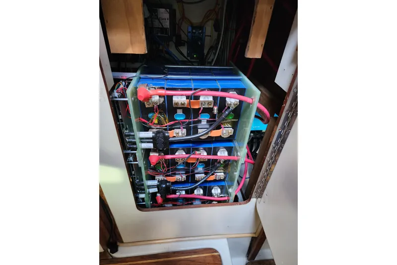 Slide: The Image of Battery setup inside a 1987 Irwin 44 sailboat, featuring wiring and connections. - 49