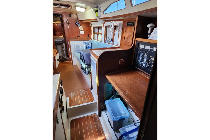 Slide: The Image of Interior of 1987 Irwin 44 sailboat, featuring wooden cabinetry and seating area. - 56
