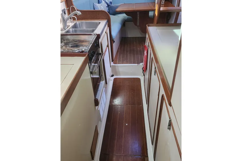 Slide: The Image of Interior of 1987 Irwin 44 sailboat with kitchen and seating area. - 59