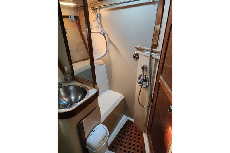 Slide: The Image of 1987 Irwin 44 yacht bathroom with sink, shower, and wooden accents. - 61