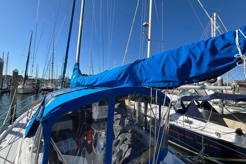 Slide: The Image of 1987 Irwin 44 sailboat with blue sail cover docked in marina. - 7