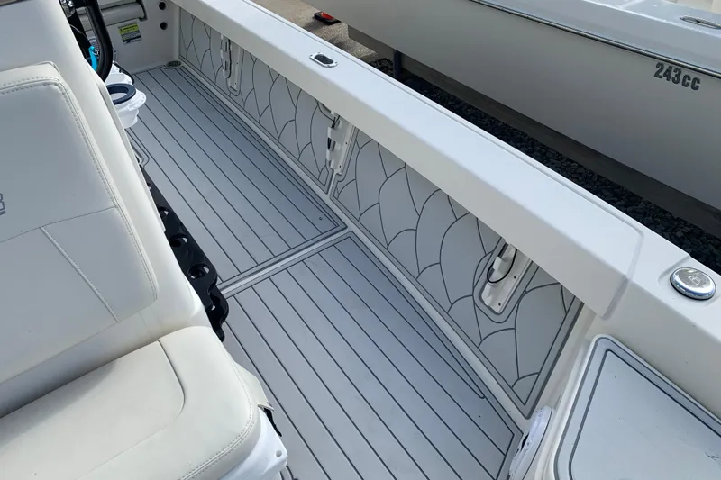 Slide: The Image of 2017 Pathfinder 2400 TRS boat interior with white seating and patterned flooring. - 11