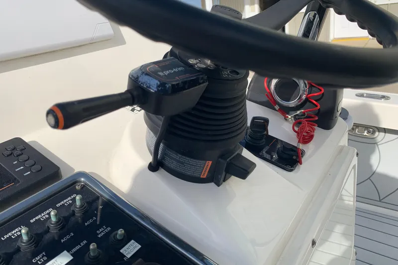 Slide: The Image of Close-up of 2017 Pathfinder 2400 TRS boat controls and steering wheel. - 16