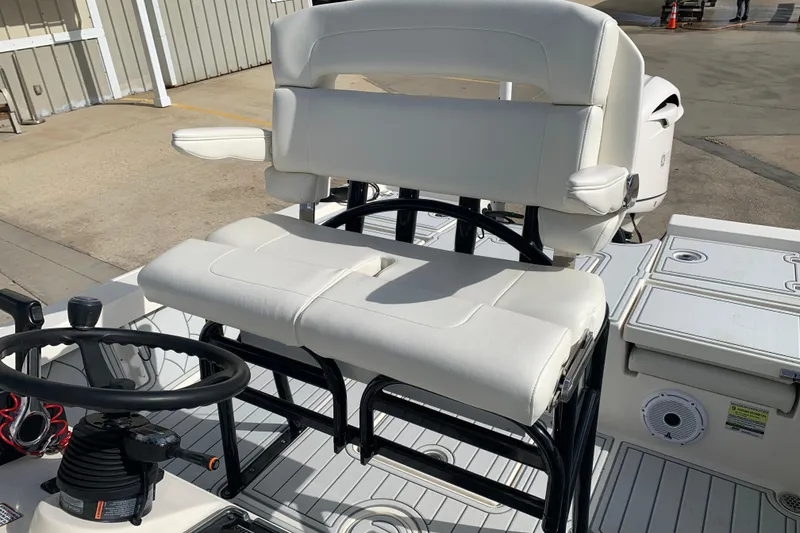 Slide: The Image of 2017 Pathfinder 2400 TRS boat interior with white seating and steering wheel. - 18