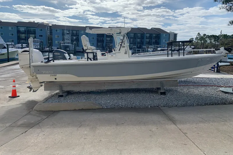 Slide: The Image of 2017 Pathfinder 2400 TRS boat on display at marina with buildings in background. - 2
