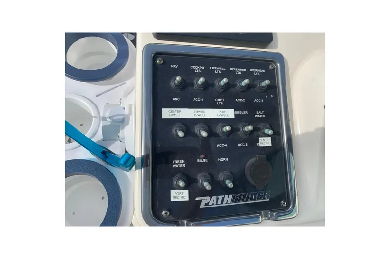 Slide: The Image of Control panel of a 2017 Pathfinder 2400 TRS boat with various switches and labels. - 20