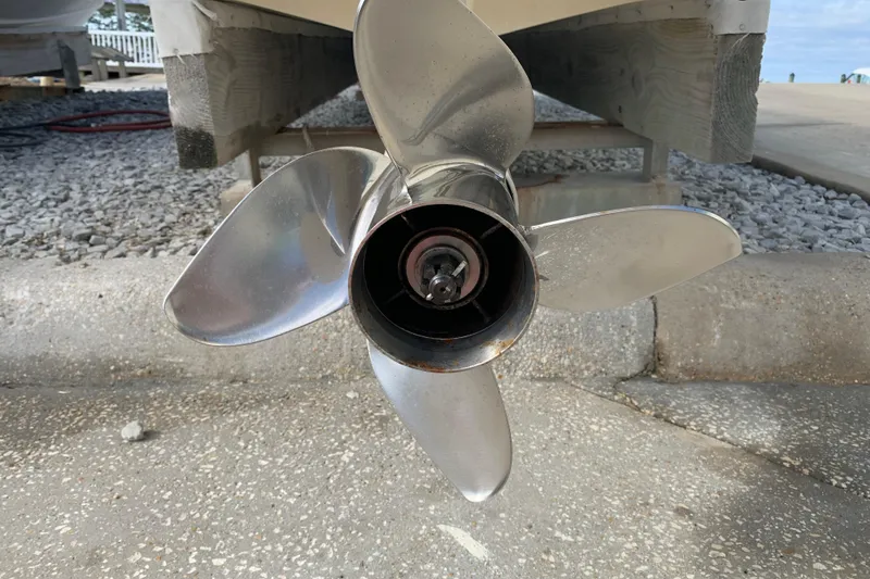 Slide: The Image of Close-up of a 2017 Pathfinder 2400 TRS boat propeller on a concrete surface. - 23