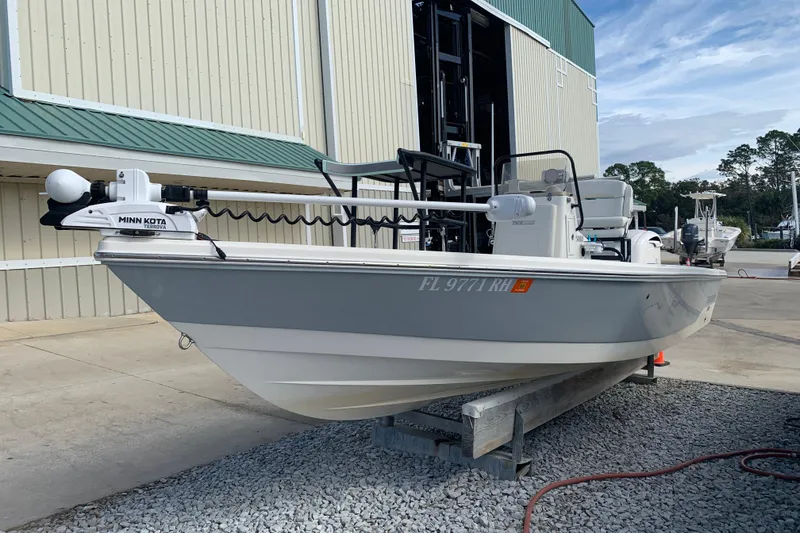 Slide: The Image of 2017 Pathfinder 2400 TRS boat with Minn Kota motor, docked on gravel. - 3