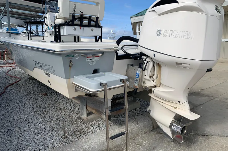 Slide: The Image of 2017 Pathfinder 2400 TRS boat with Yamaha outboard motor, docked on gravel. - 5