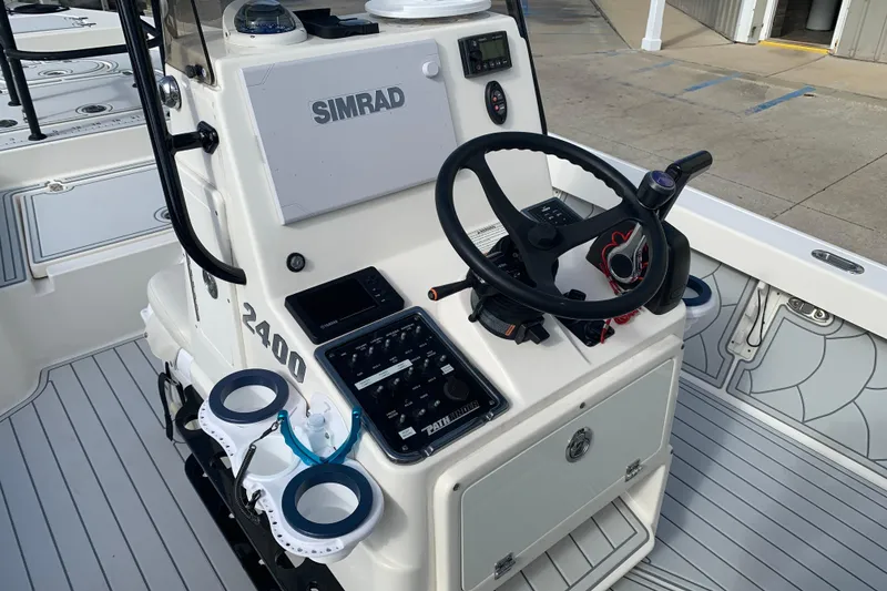 Slide: The Image of 2017 Pathfinder 2400 TRS boat console with steering wheel and Simrad electronics. - 6