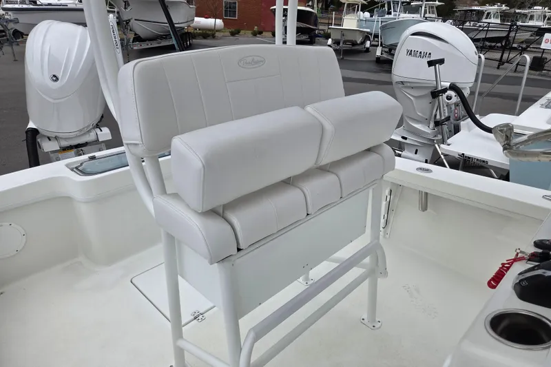 Slide: The Image of 2026 Pair Customs 21 Center Console MV boat interior with white seating and Yamaha engine. - 12