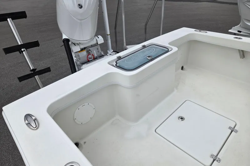 Slide: The Image of 2026 Pair Customs 21 Center Console MV boat interior with storage compartments and motor. - 14