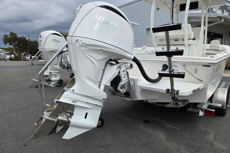 Slide: The Image of 2026 Pair Customs 21 Center Console MV with Yamaha outboard motor, parked on a trailer. - 2