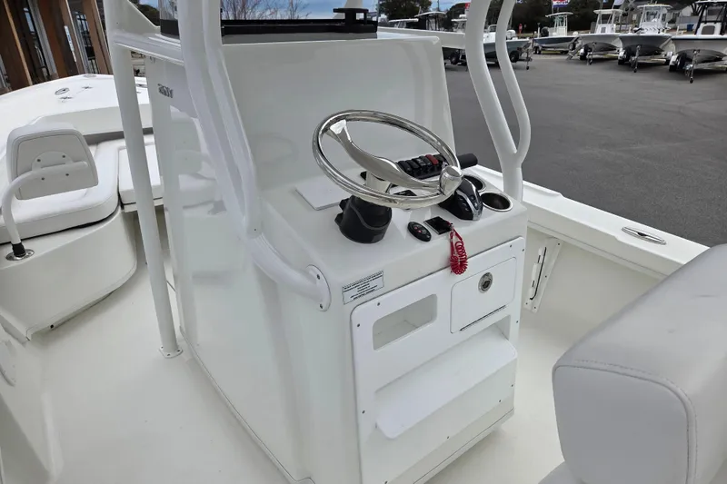 Slide: The Image of 2026 Pair Customs 21 Center Console MV boat interior with steering wheel and controls. - 8