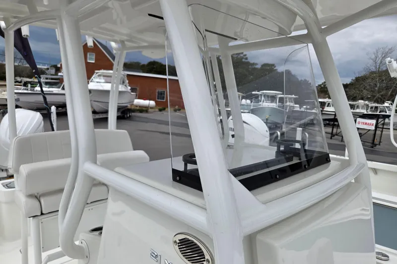 Slide: The Image of 2026 Pair Customs 21 Center Console MV boat with sleek design in marina setting. - 9