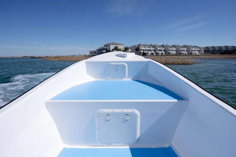 Slide: The Image of Imemsa W25BA 2021 boat cruising near coastal buildings under clear blue sky. - 12