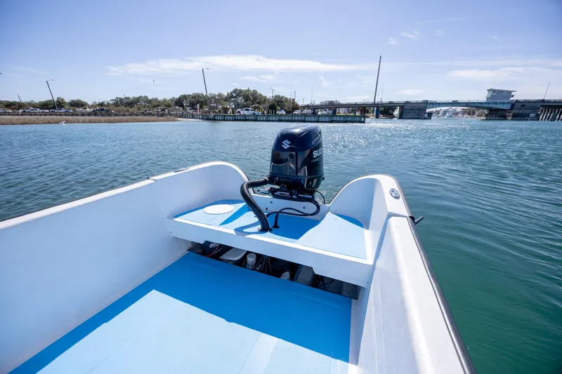 Slide: The Image of 2021 Imemsa W25BA boat with Suzuki outboard motor on calm water near a bridge. - 14