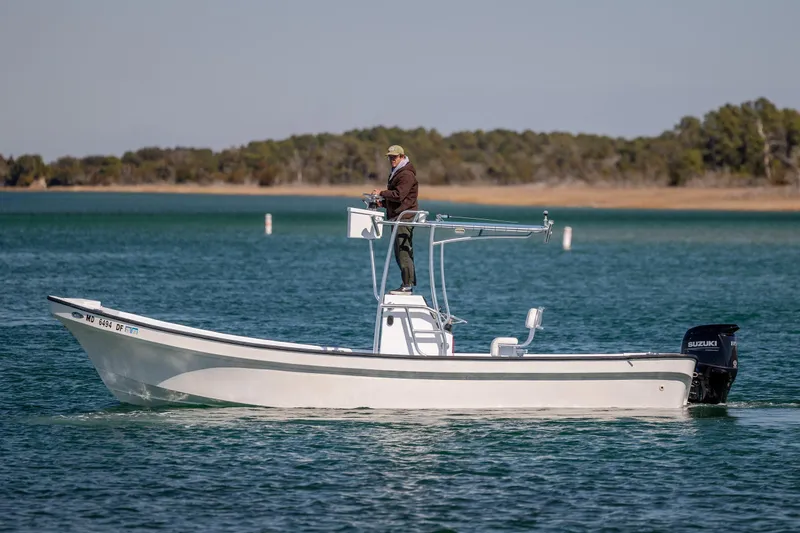 Slide: The Image of A person stands on a 2021 Imemsa W25BA boat in a calm lake. - 3