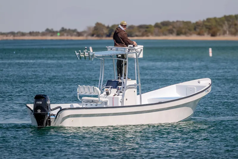 Slide: The Image of 2021 Imemsa W25BA boat with elevated helm, cruising on calm water. - 5