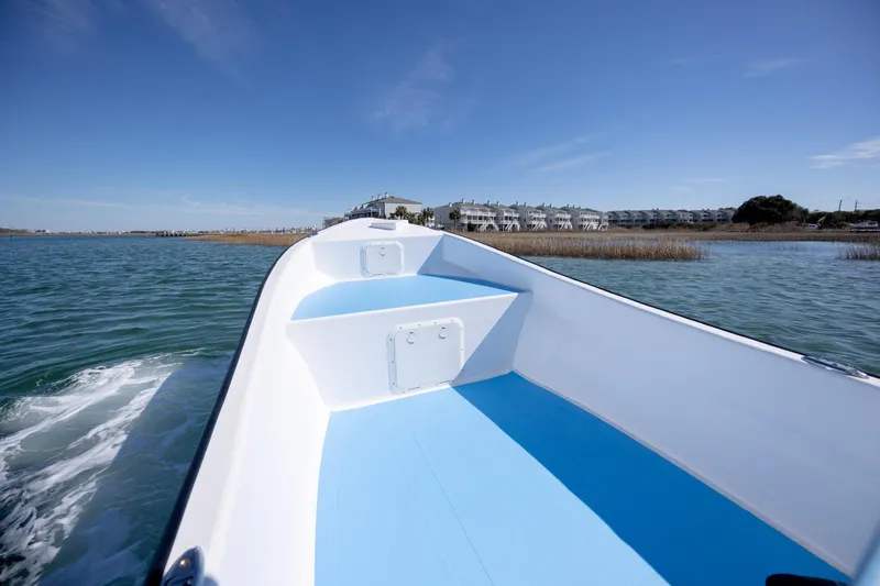 Slide: The Image of 2021 Imemsa W25BA boat cruising on a sunny day near coastal buildings. - 8