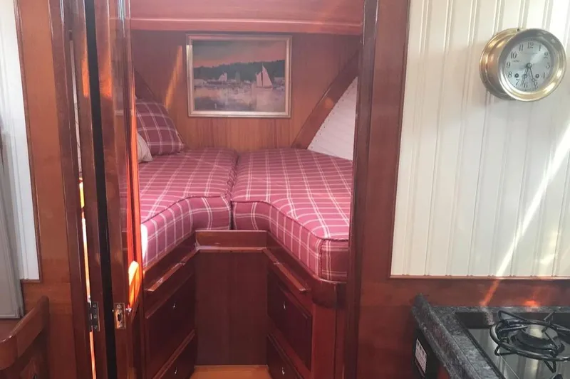 Slide: The Image of Cozy cabin interior of 2005 Lyman-Morse Monhegan yacht with plaid bedding and nautical decor. - 13