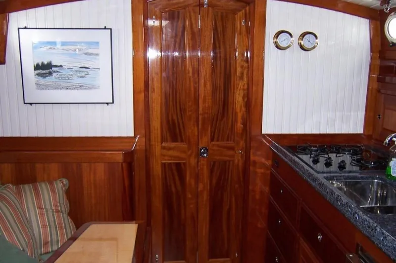Slide: The Image of Interior of 2005 Lyman-Morse Monhegan yacht with wood finish and compact kitchen. - 15