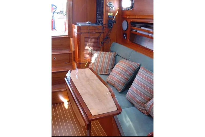 Slide: The Image of Interior of 2005 Lyman-Morse Monhegan yacht with wooden finish and striped cushions. - 16