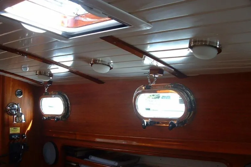 Slide: The Image of Interior of 2005 Lyman-Morse Monhegan yacht with wooden paneling and portholes. - 17
