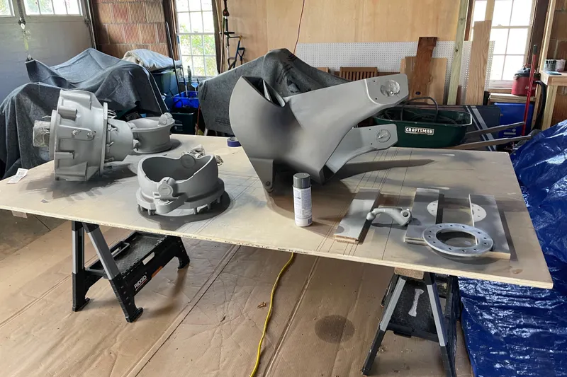 Slide: The Image of Boat parts from a 2005 Lyman-Morse Monhegan, displayed on a workbench in a garage. - 19