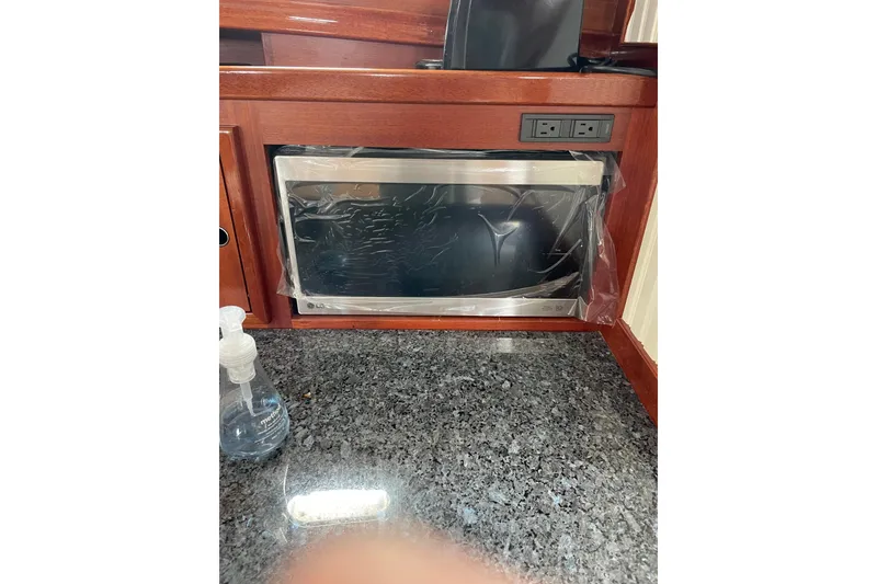 Slide: The Image of Built-in microwave in Lyman-Morse Monhegan 2005 yacht kitchen with granite countertop. - 24