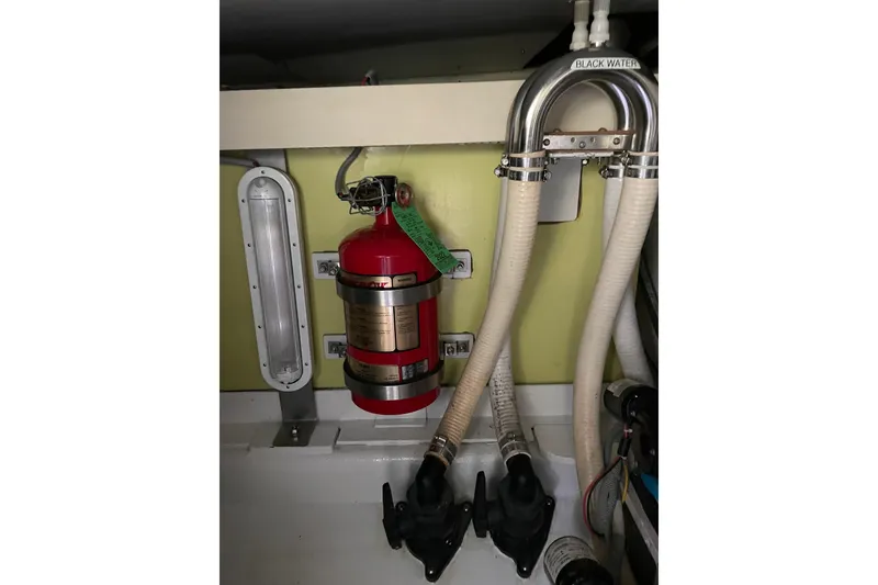 Slide: The Image of Engine room of 2005 Lyman-Morse Monhegan with fire extinguisher and plumbing. - 25