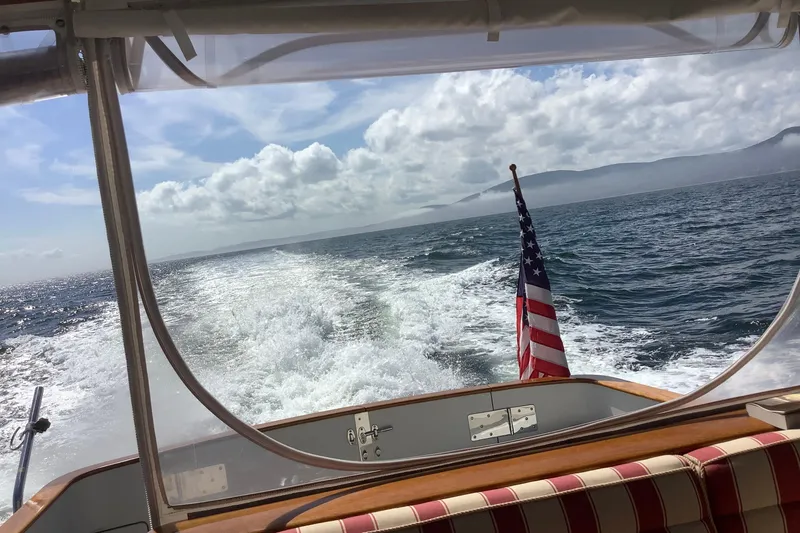 Slide: The Image of 2005 Lyman-Morse Monhegan boat cruising with American flag, ocean view. - 26