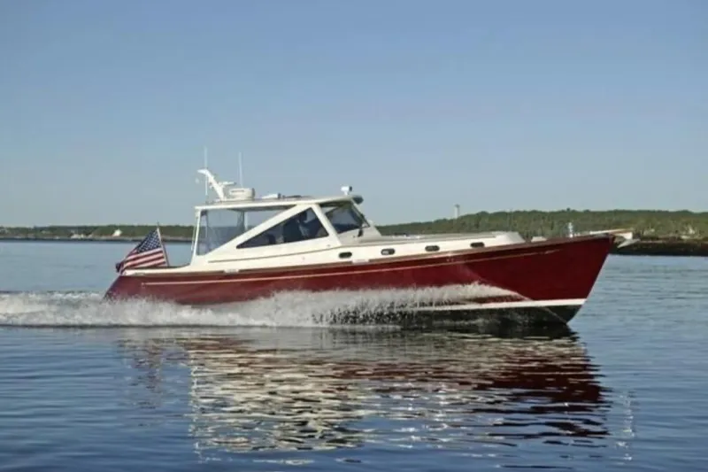 Slide: The Image of 2005 Lyman-Morse Monhegan boat cruising on calm water with American flag. - 27