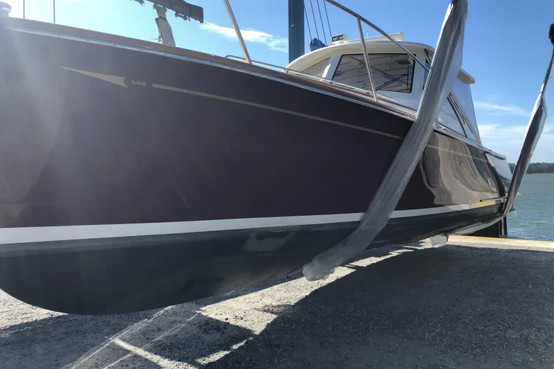 Slide: The Image of 2005 Lyman-Morse Monhegan boat on lift, side view with clear sky background. - 3