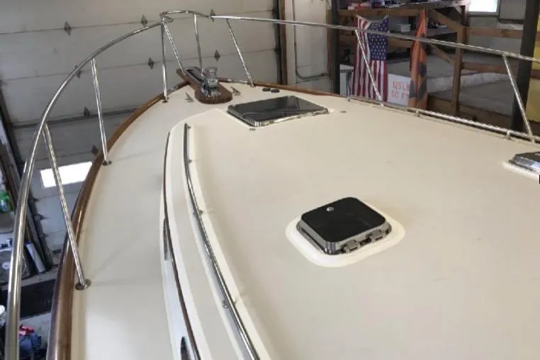 Slide: The Image of 2005 Lyman-Morse Monhegan yacht deck with railings and hatches in a garage setting. - 7