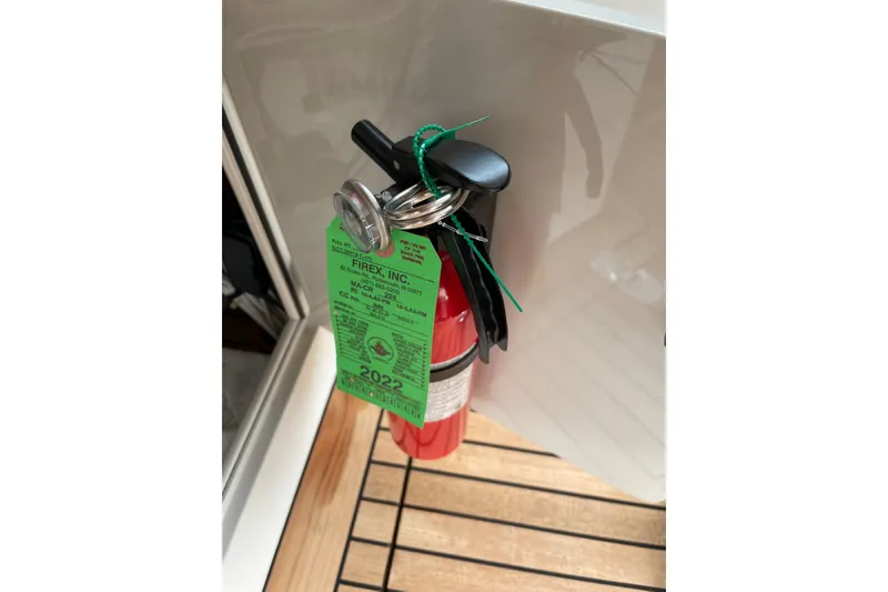 Slide: The Image of Red fire extinguisher with inspection tag on Lyman-Morse Monhegan 2005 boat. - 9