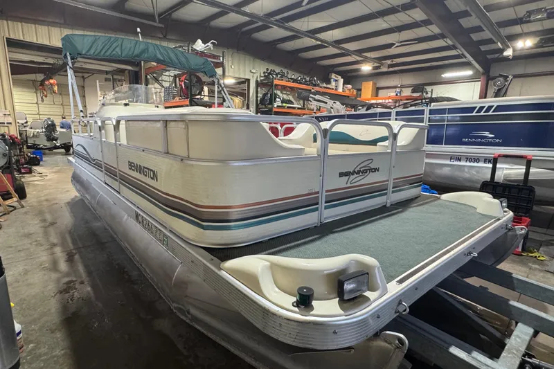 Slide: The Image of 2000 Bennington 205 L pontoon boat in a workshop setting. - 3