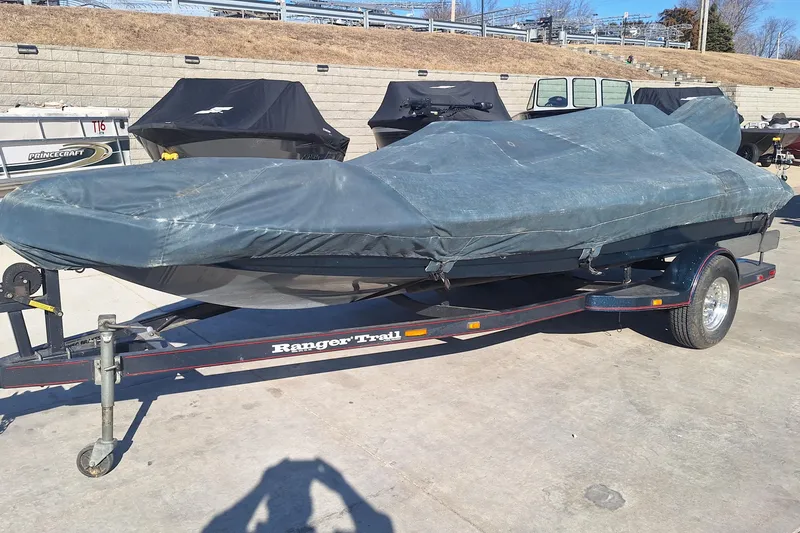 Slide: The Image of 1994 Ranger 481VS boat covered on a trailer, parked outdoors. - 10
