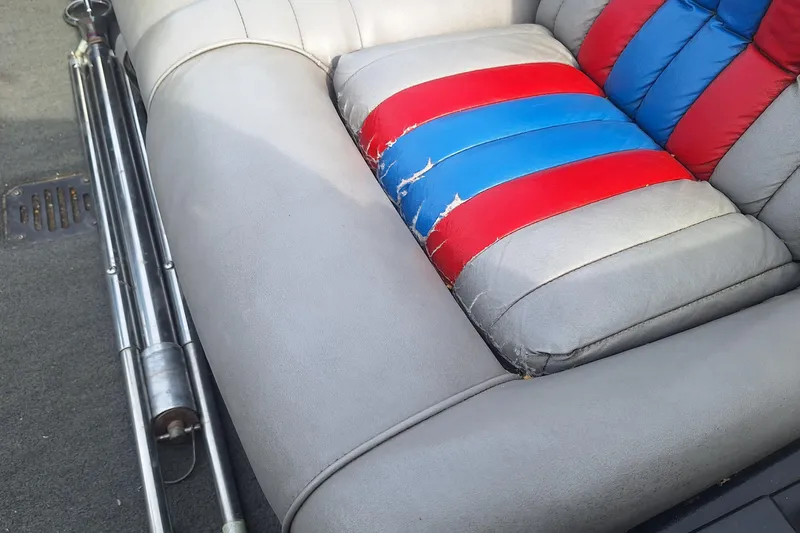 Slide: The Image of 1994 Ranger 481VS boat seat with red and blue stripes, showing wear and tear. - 14